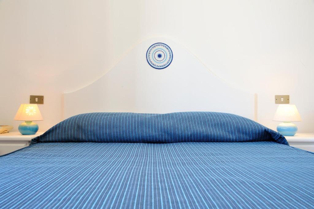 Postel nebo postele na pokoji v ubytování Hotel Agugliastra