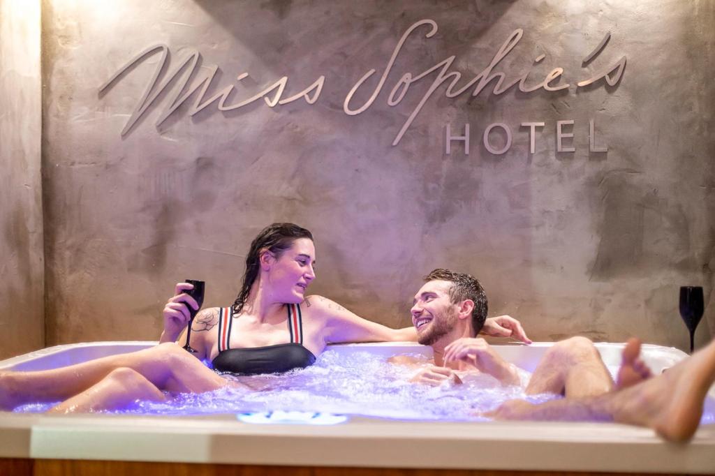 a man and a woman in a hot tub at Miss Sophie's New Town & Wellness in Prague