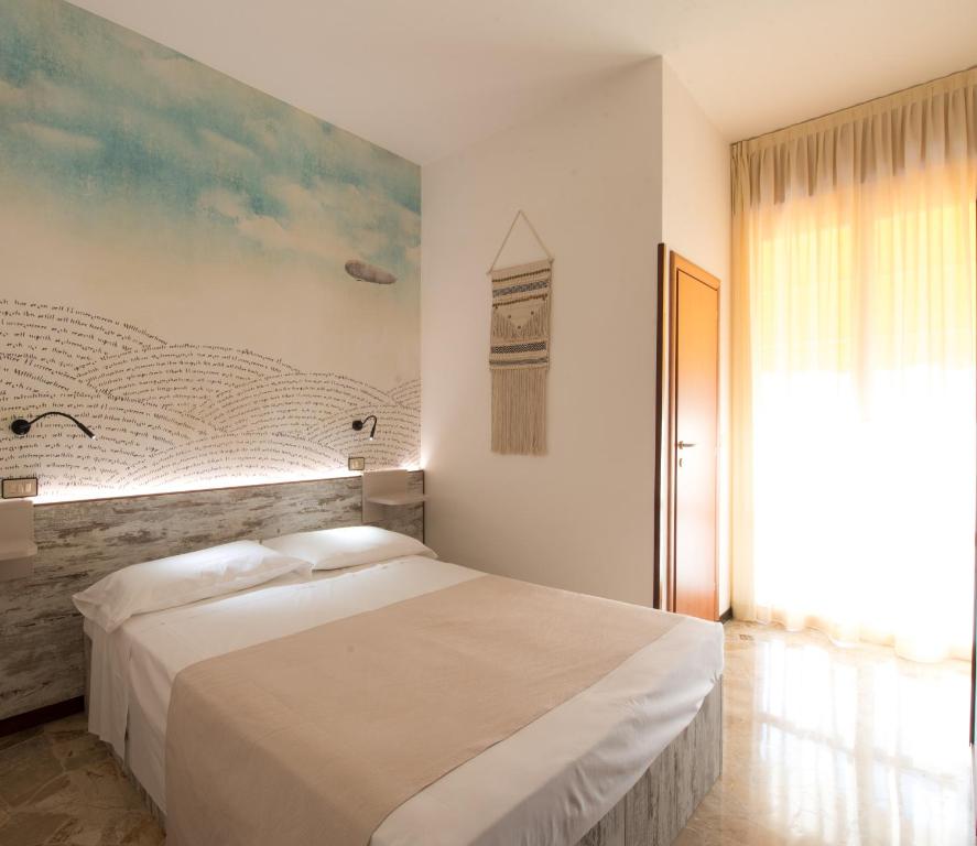 Postel nebo postele na pokoji v ubytování Hotel Fabrizio