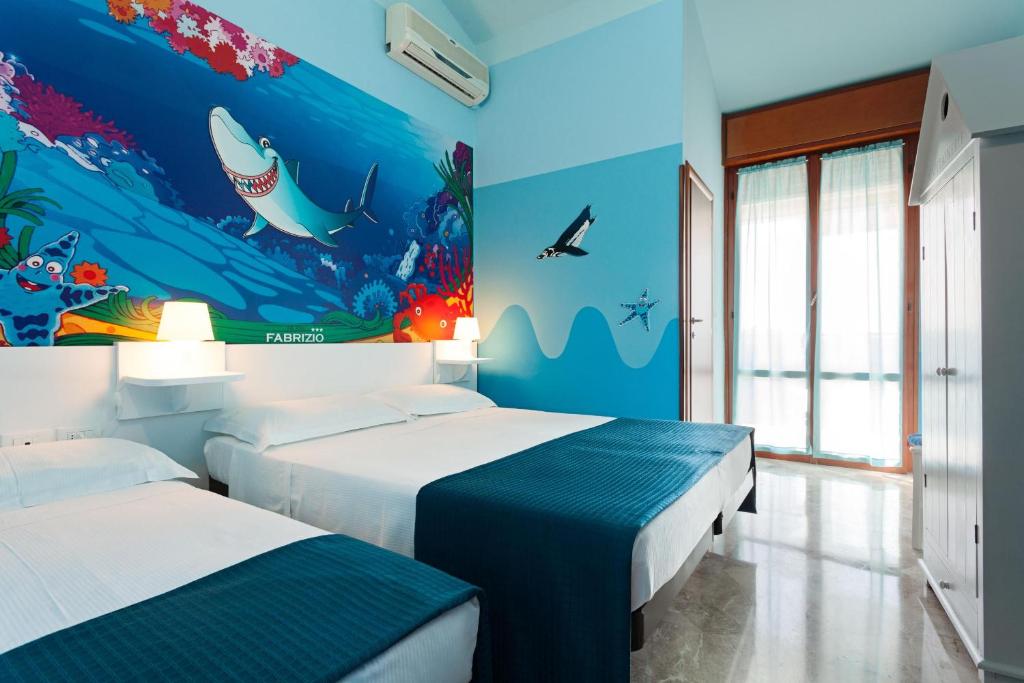 Postel nebo postele na pokoji v ubytování Hotel Fabrizio