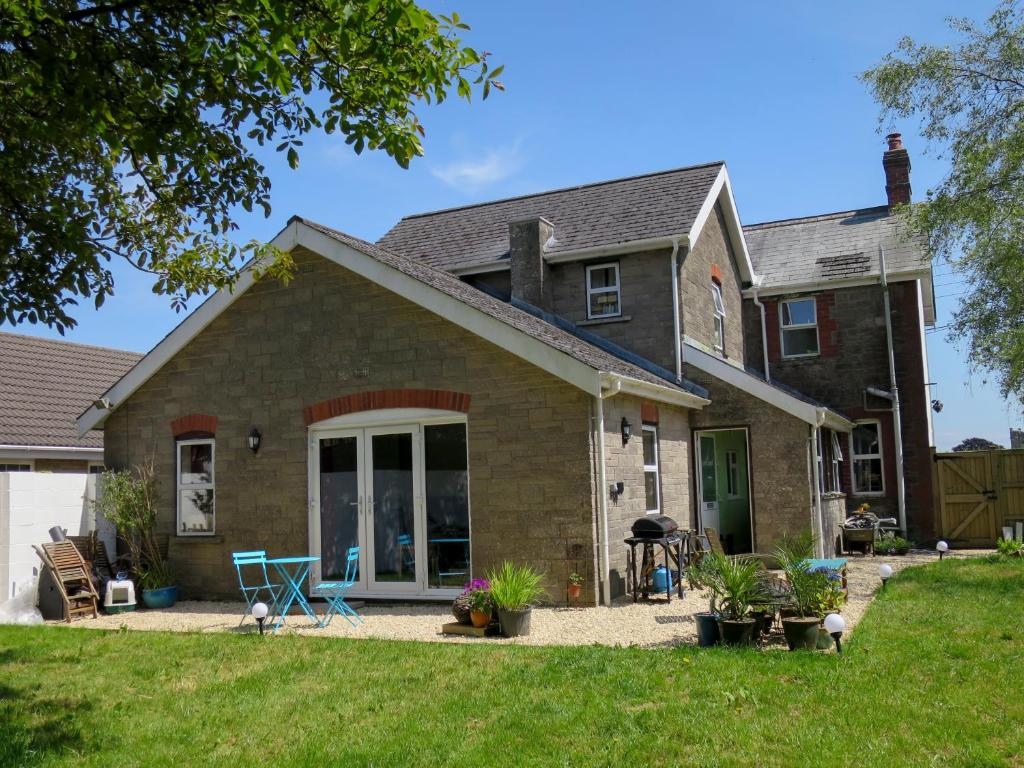 a house with a patio and a yard at Hill View in Binegar