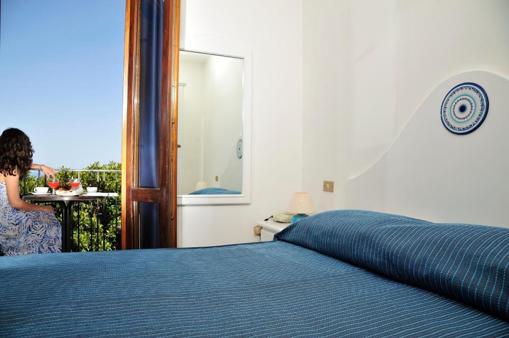 Postel nebo postele na pokoji v ubytování Hotel Agugliastra