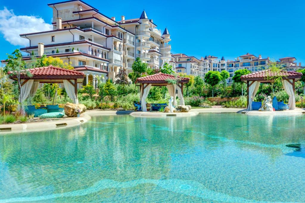 a swimming pool in front of a building at Poseidon VIP Residence Club Balneo & SPA Resort in Nesebar