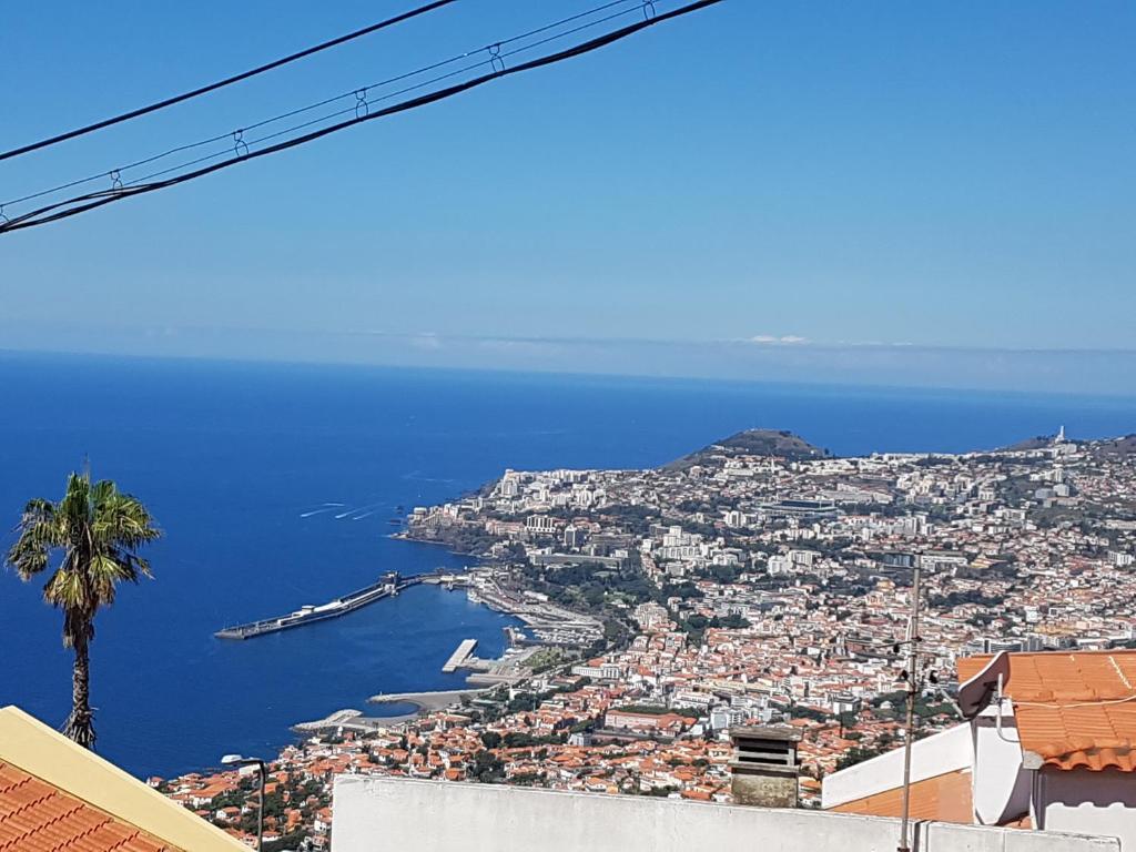 a view of the city of positano and the ocean at A Slice of Paradise - Palheiro Golf in Funchal