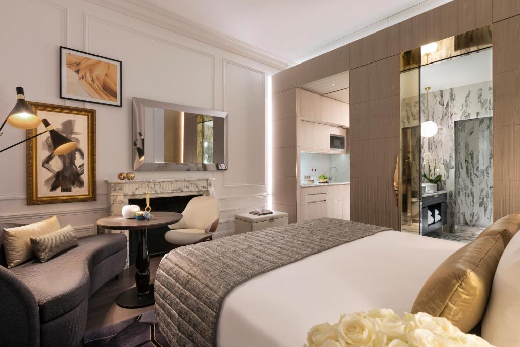 a hotel room with a bed and a living room at La Clef Champs-Élysées Paris by The Crest Collection in Paris