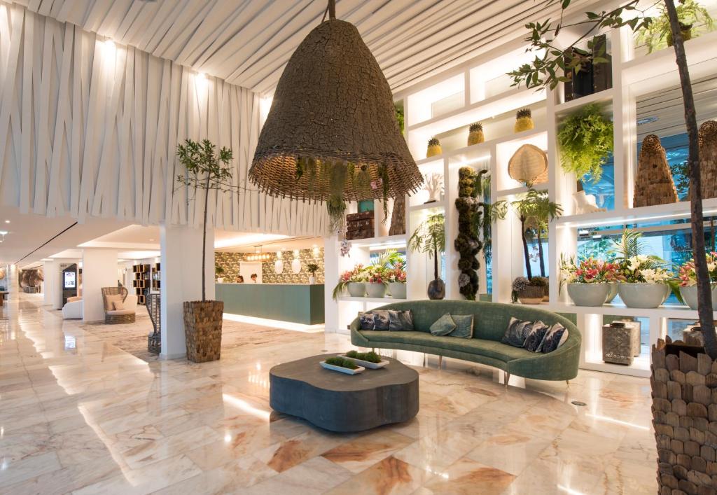 a lobby with a couch and a table in a store at Hotel Alto Lido in Funchal