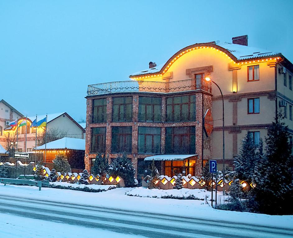 a building on a street in the snow at Hotel Kilikiya in Uzhhorod