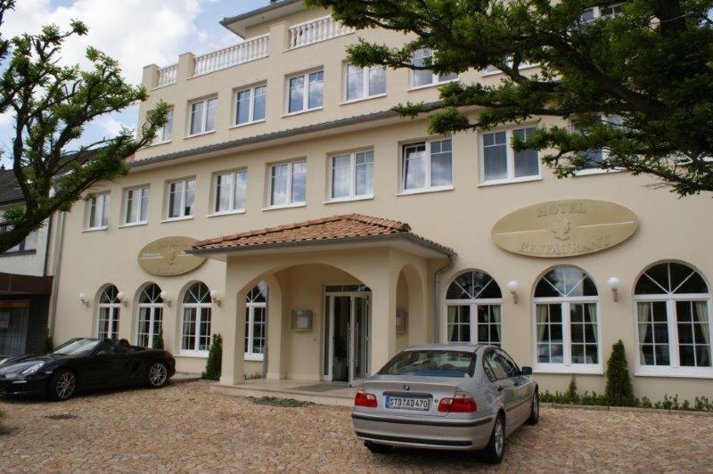 a large building with cars parked in front of it at Hotel Helena in Neu Wulmstorf