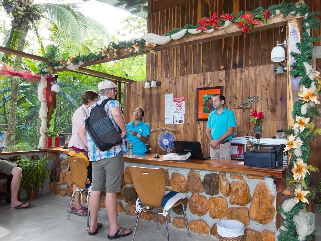 a group of people standing in front of a bar at Arenal Xilopalo in Fortuna