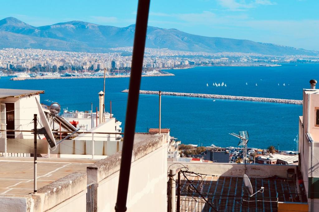 a view of the city and the ocean from a building at Perfect View in Piraeus