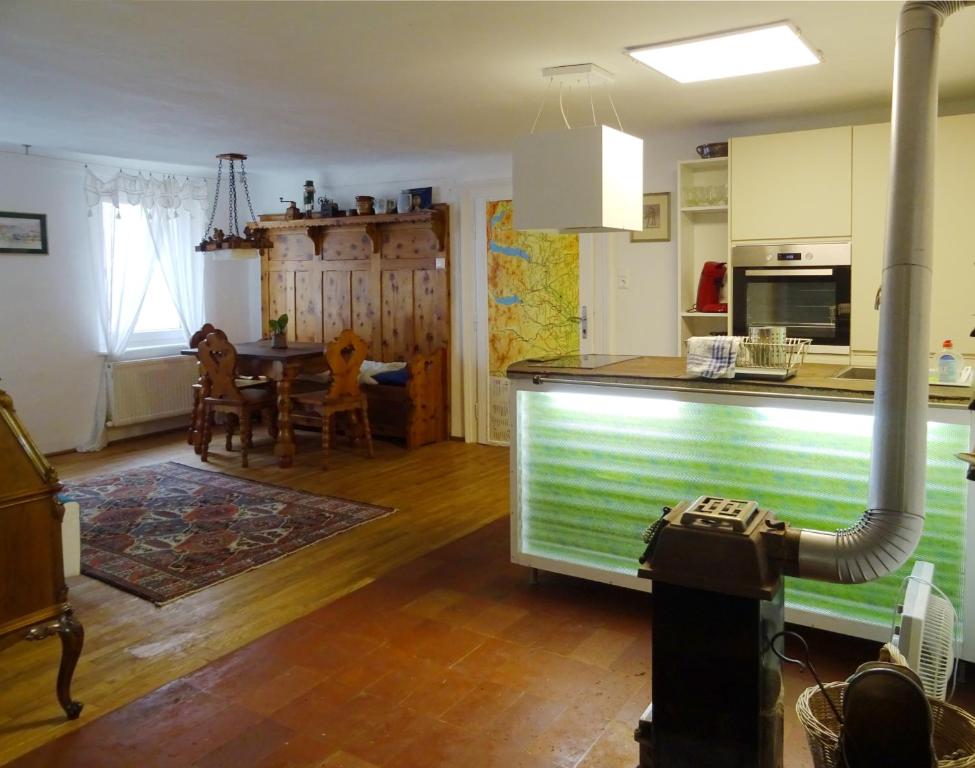 a kitchen with a counter and a table in a room at Apartment Center in Gmunden