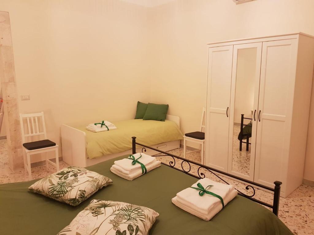 - une chambre avec 2 lits et une armoire avec des serviettes dans l'établissement CASA CAIROLI PUTIGNANO, à Putignano