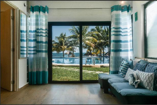 a living room with a couch and a view of a pool at Casita del Mar in Cancún