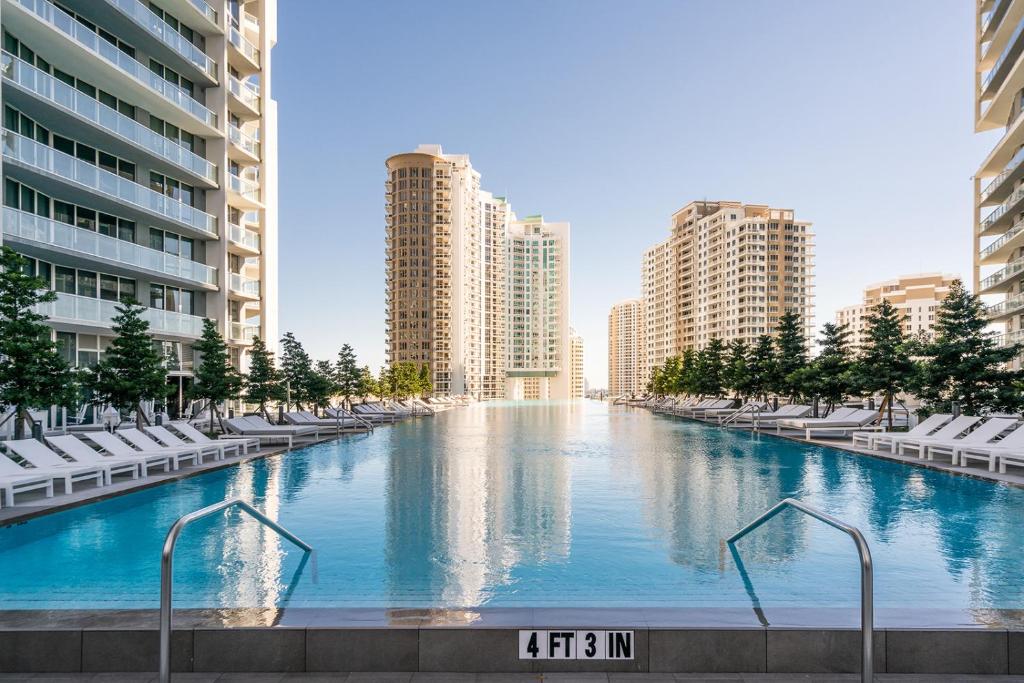 a large swimming pool in a city with buildings at ICON Brickell residences in Miami