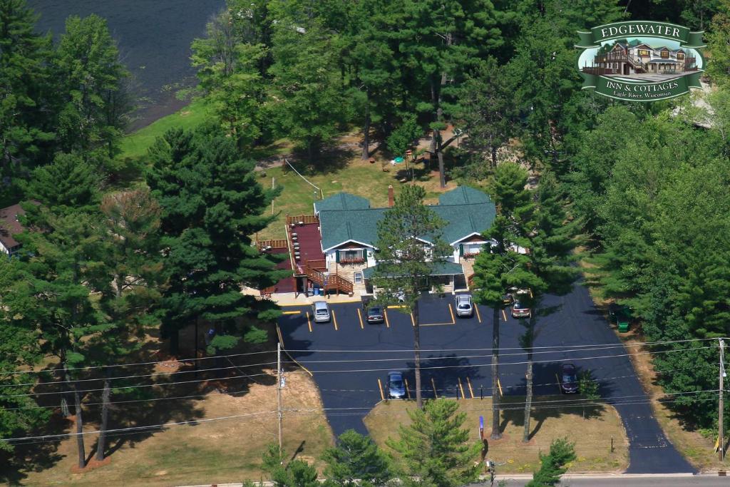 an aerial view of a house with a parking lot at Edgewater Inn & Cottages in Eagle River