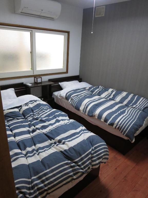 Postel nebo postele na pokoji v ubytování SappoLodge