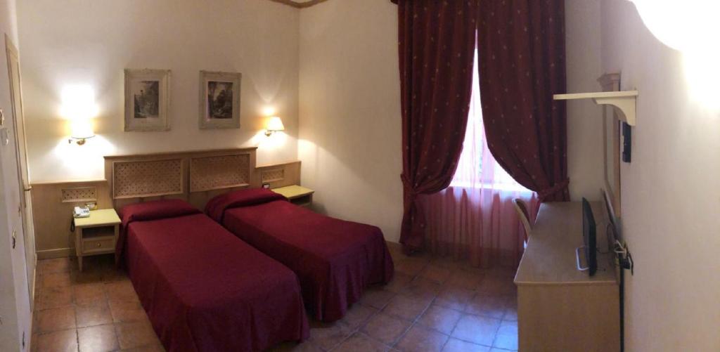 Postel nebo postele na pokoji v ubytování Hotel Quadrifoglio by Mancini