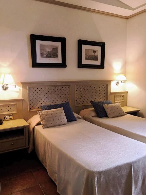 Postel nebo postele na pokoji v ubytování Hotel Quadrifoglio by Mancini