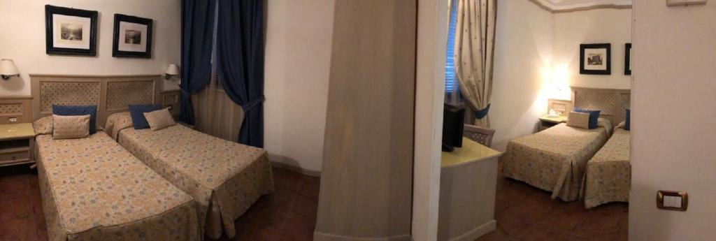 Postel nebo postele na pokoji v ubytování Hotel Quadrifoglio by Mancini