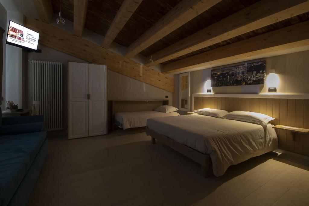 Posteľ alebo postele v izbe v ubytovaní Hotel Laghetto