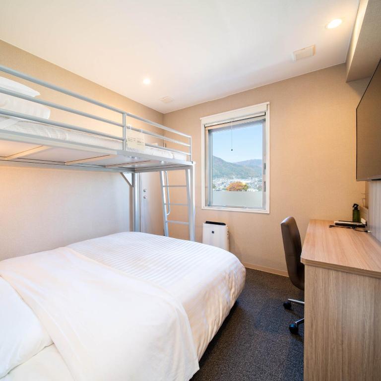 Postel nebo postele na pokoji v ubytování Super Hotel Nagano Iida Inter