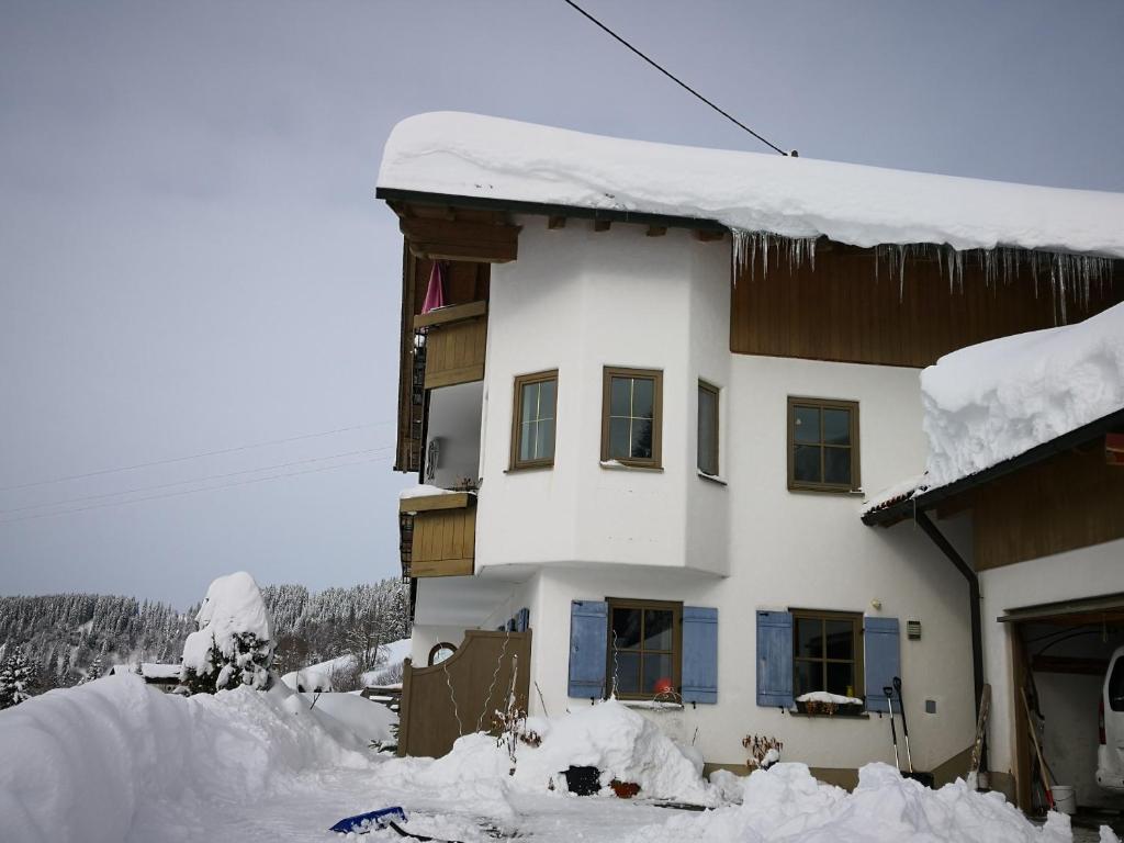 a building covered in snow with snow around it at Jungholz Erlebnis in Jungholz