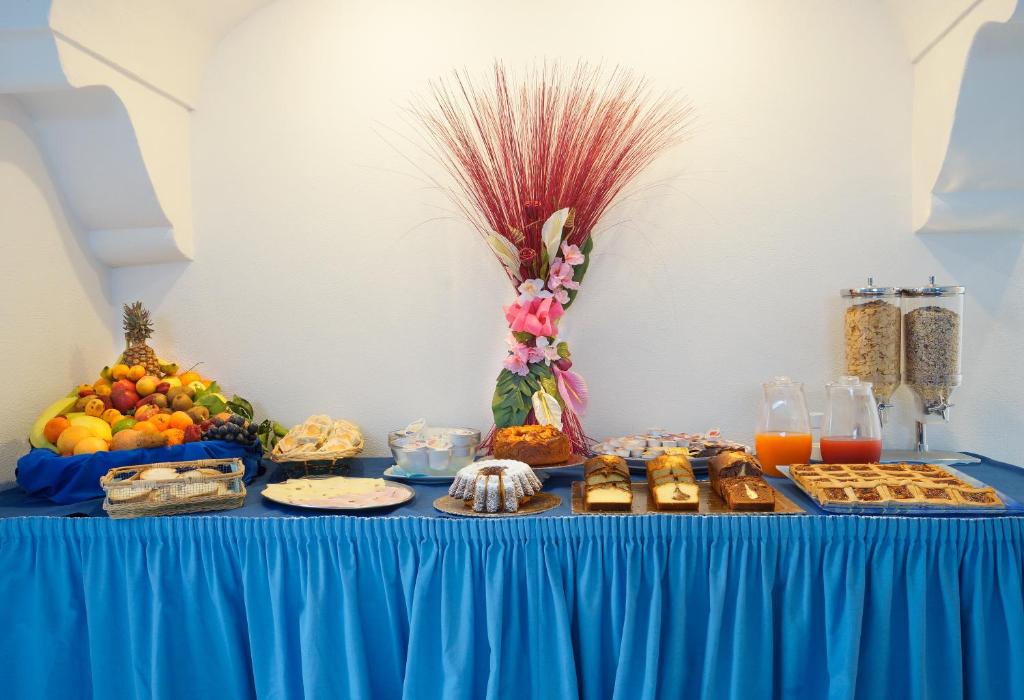 a blue table with a buffet of food on it at Iris Hotel in Ischia