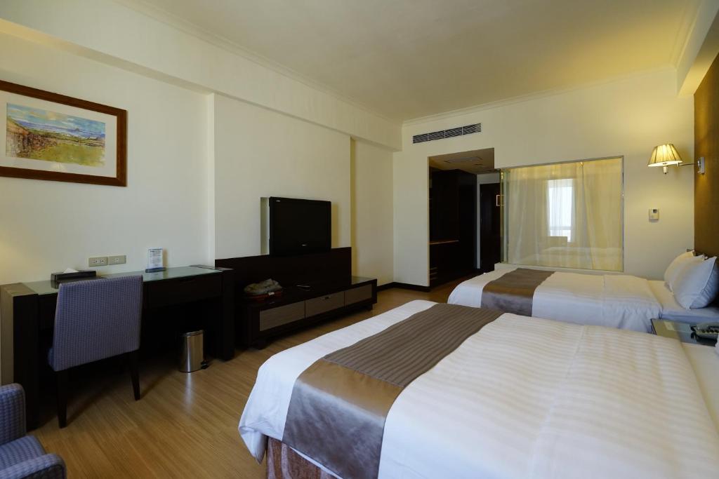 Postel nebo postele na pokoji v ubytování Hai Yue Hotel
