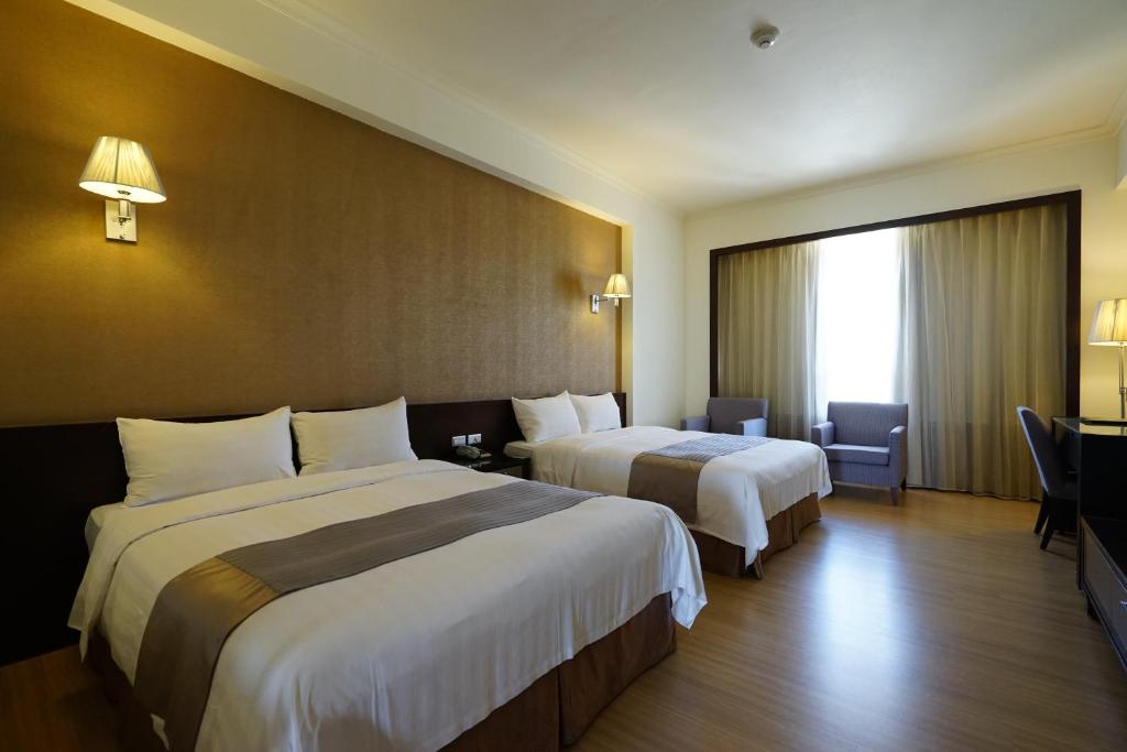 Postel nebo postele na pokoji v ubytování Hai Yue Hotel
