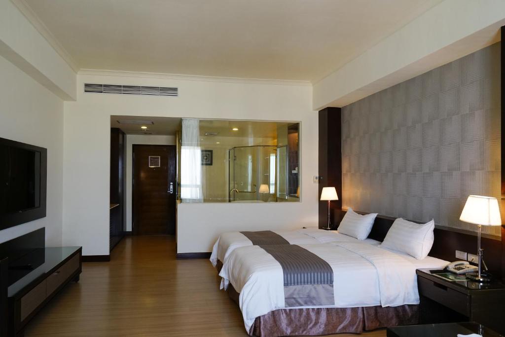 Postel nebo postele na pokoji v ubytování Hai Yue Hotel