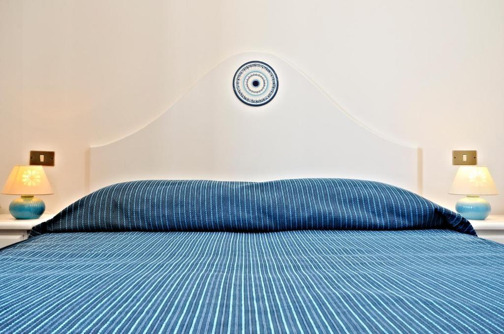 Postel nebo postele na pokoji v ubytování Hotel Agugliastra