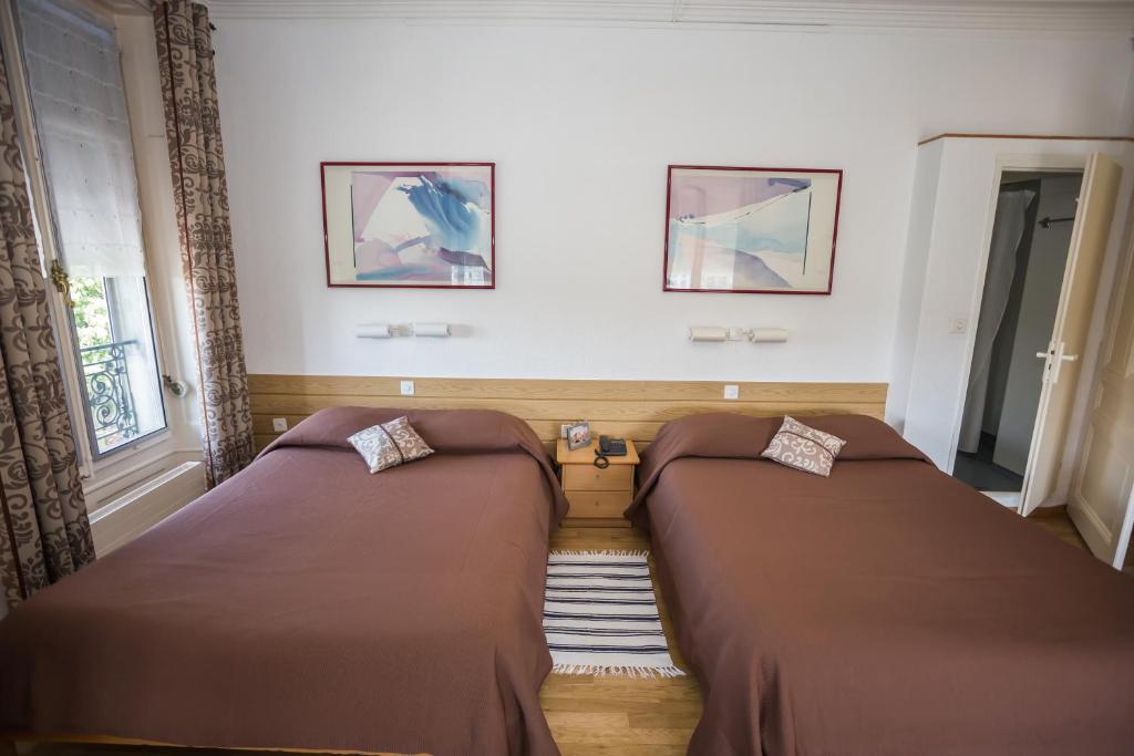 Postel nebo postele na pokoji v ubytování Hotel des Tourelles