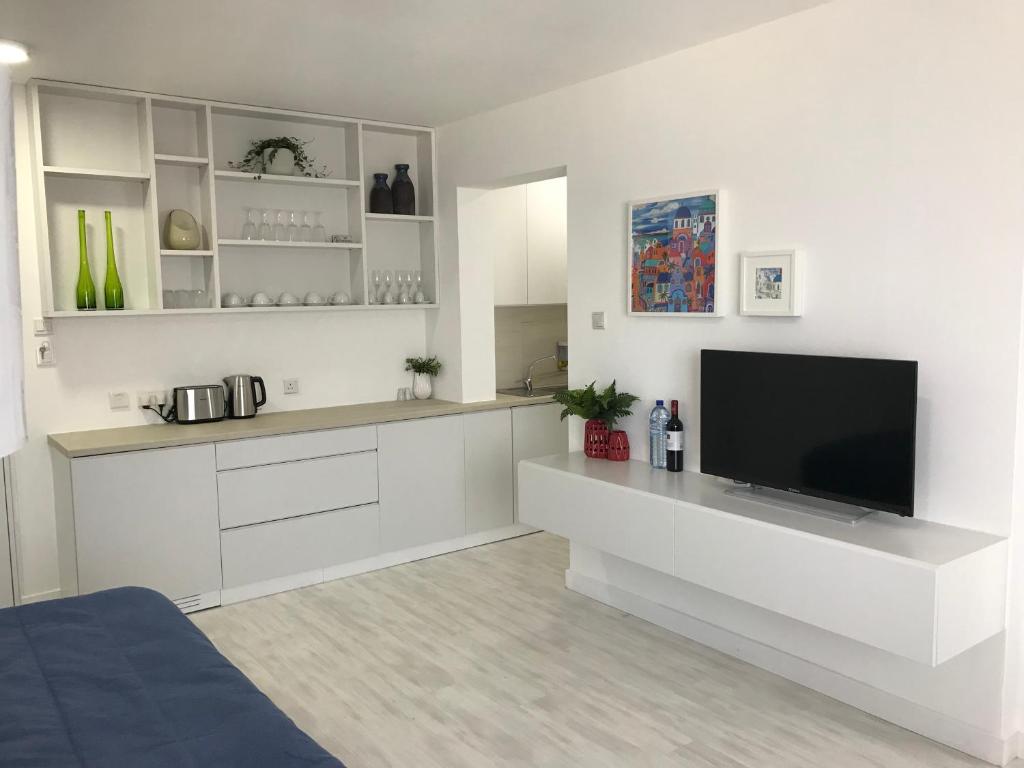 a living room with a flat screen tv on a counter at Sea View Holiday Apartment in Larnaca