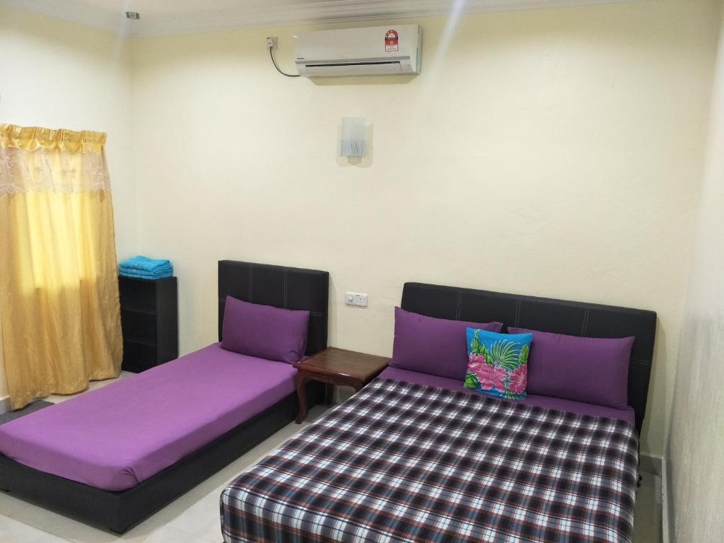 Postel nebo postele na pokoji v ubytování Motel Aurora Damai