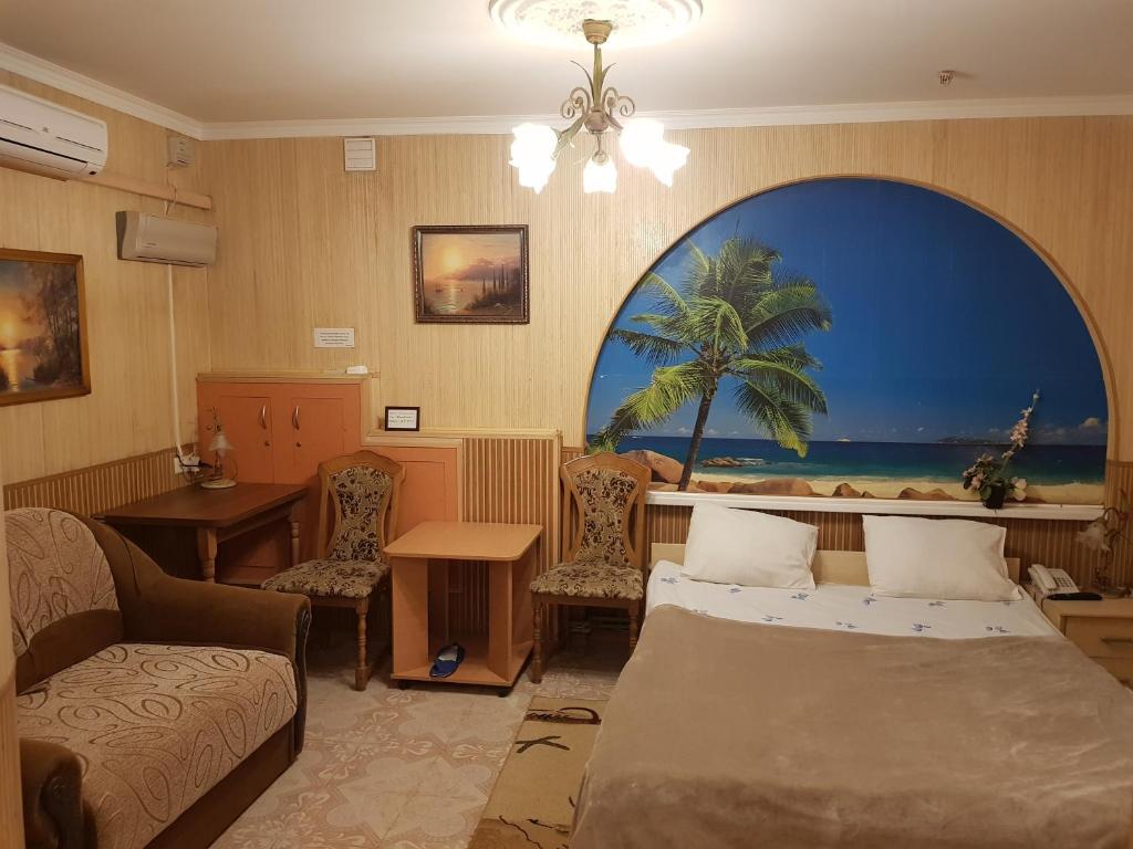 a hotel room with a bed and a table and chairs at Elena in Kherson