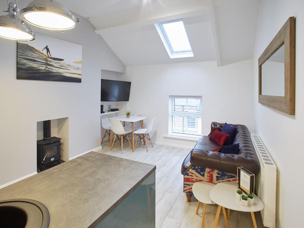 a living room with a couch and a table at Host & Stay - The Surfer's Loft Apartment in Saltburn-by-the-Sea