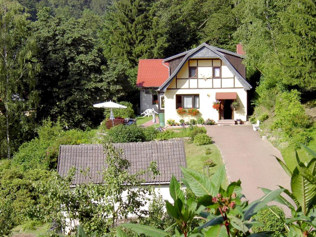 a small white house with a red roof at Birkenhain in Stolberg i. Harz