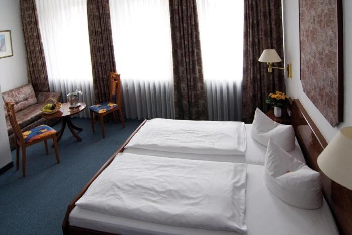 a hotel room with a bed and a table at Hotel Alter Speicher in Lübeck