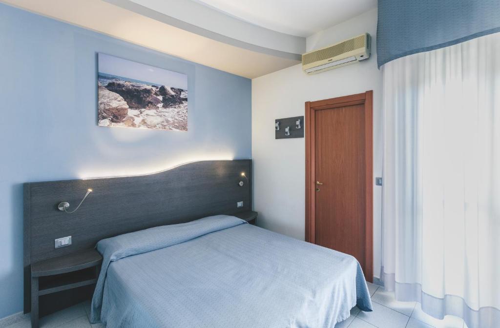 Postel nebo postele na pokoji v ubytování Hotel Acquario