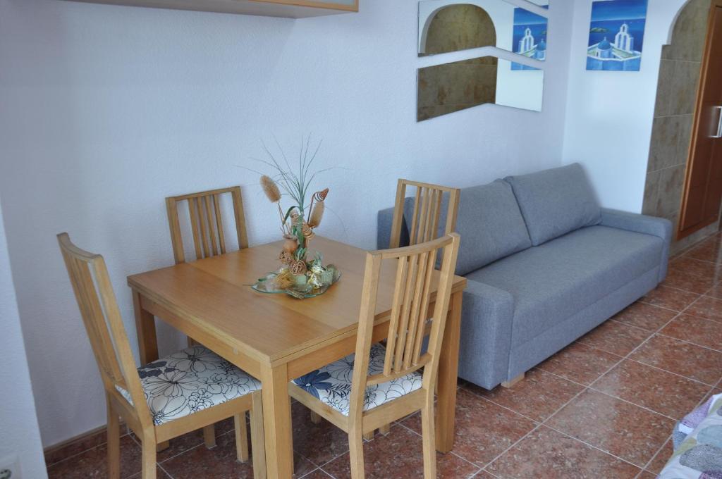 a living room with a table and a couch at Studio Vue Mer in Torremolinos