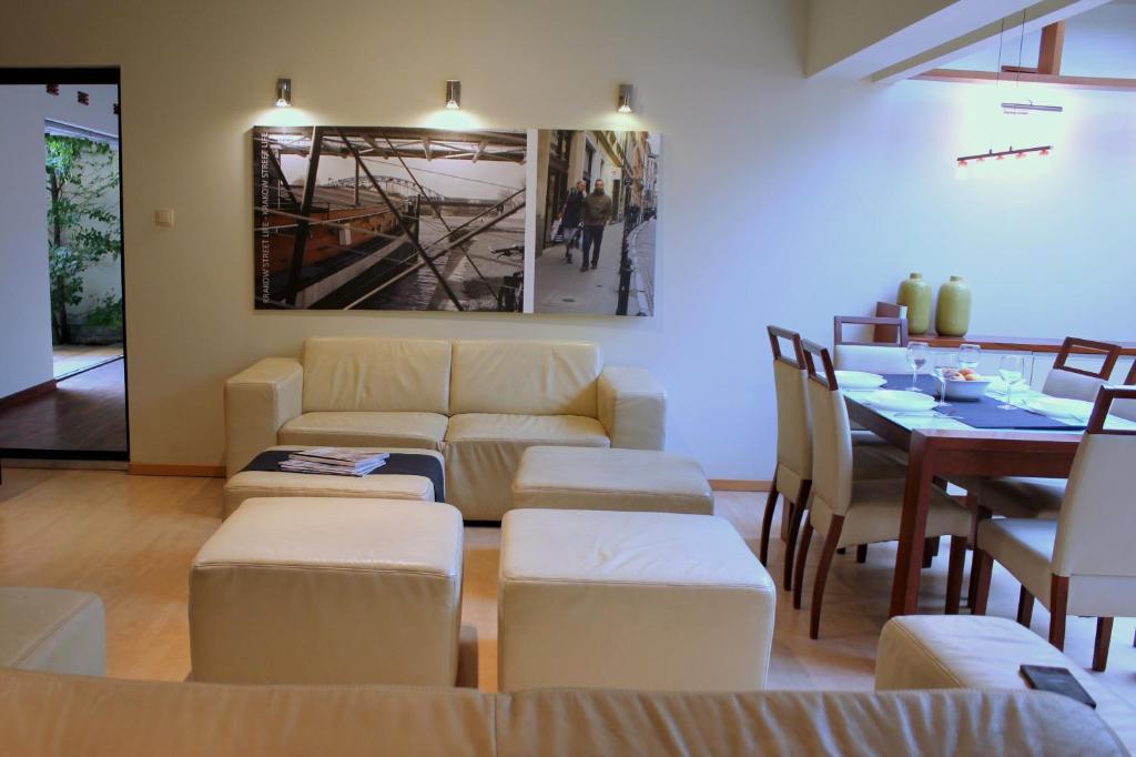 a room with couches and a table and a dining room at Apartment with GARDEN in CITY CENTER in Krakow