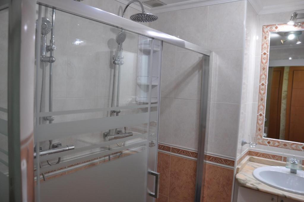 a bathroom with a shower and a sink at Studio Vue Mer in Torremolinos