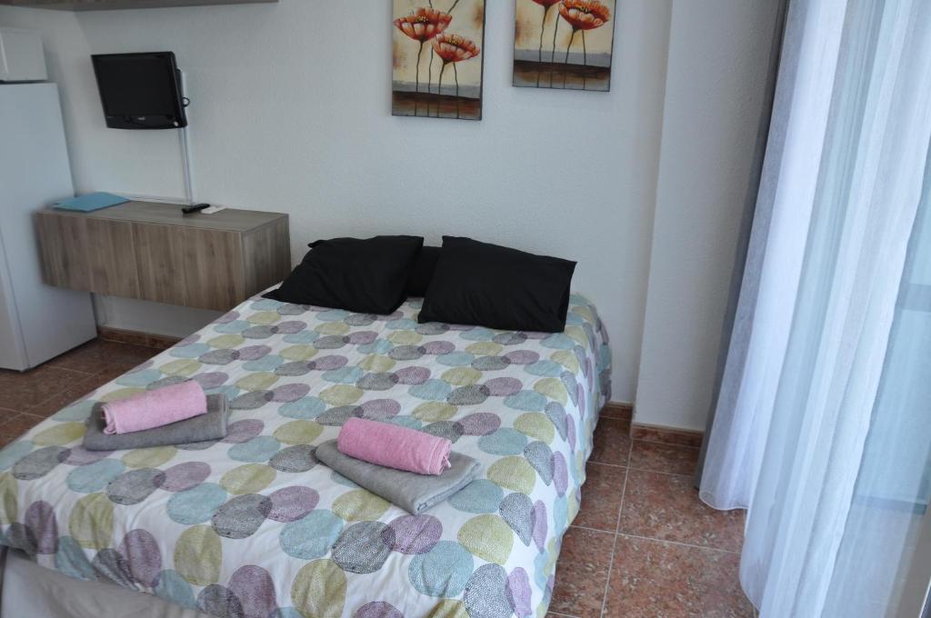 a bedroom with a bed with two pillows on it at Studio Vue Mer in Torremolinos