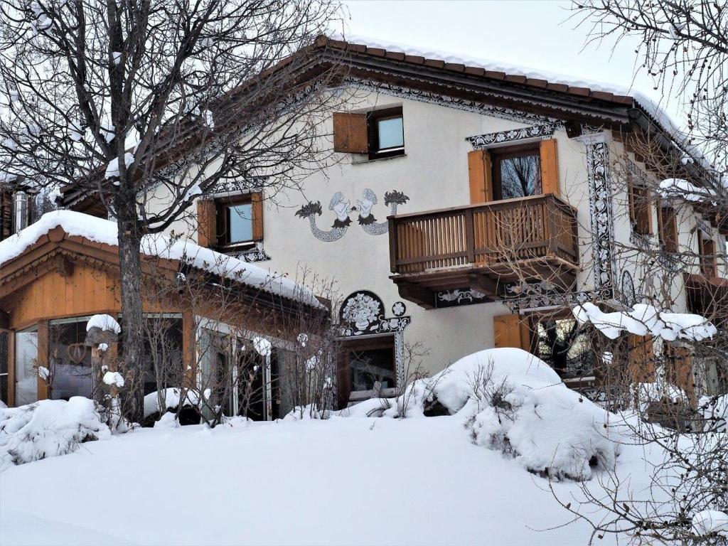 una casa cubierta de nieve delante en Chesa Sper l'Ovel Brail, en Zernez