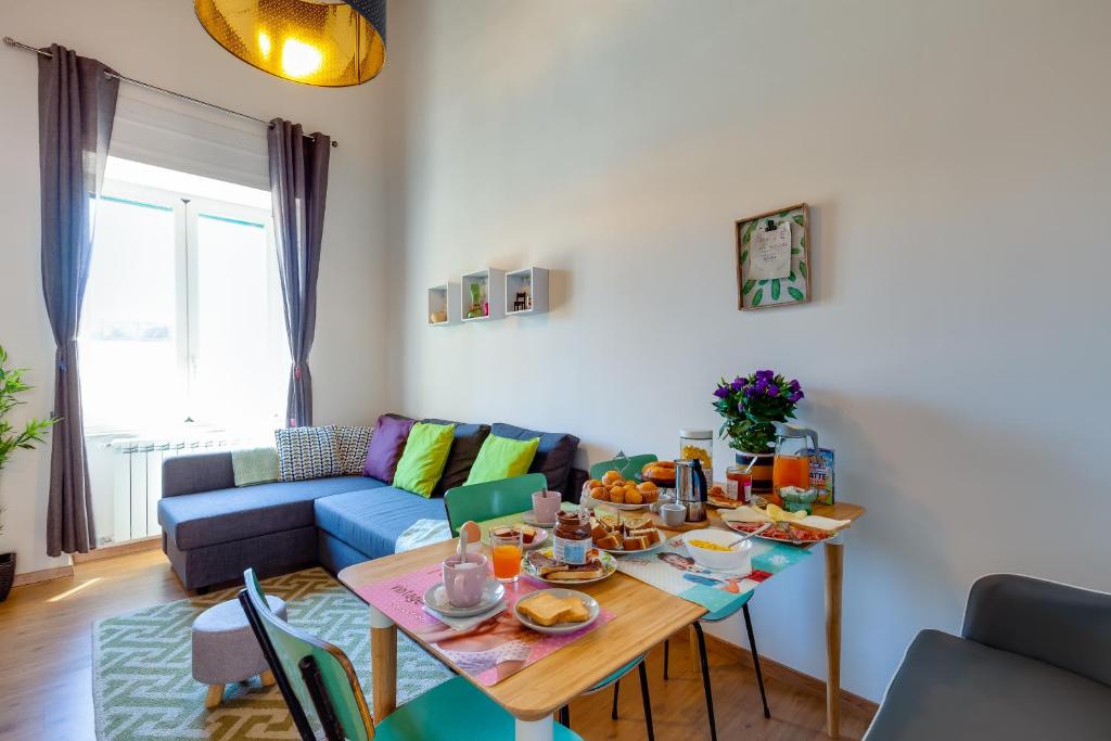 a living room with a table with food on it at Casa Vacanze Sapienza 29 in Naples