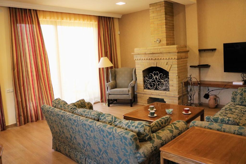 a living room with a couch and a fireplace at Modern Floor - Dilijan Garden House in Dilijan