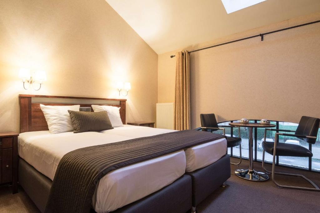 Postel nebo postele na pokoji v ubytování Turnhout City Hotel