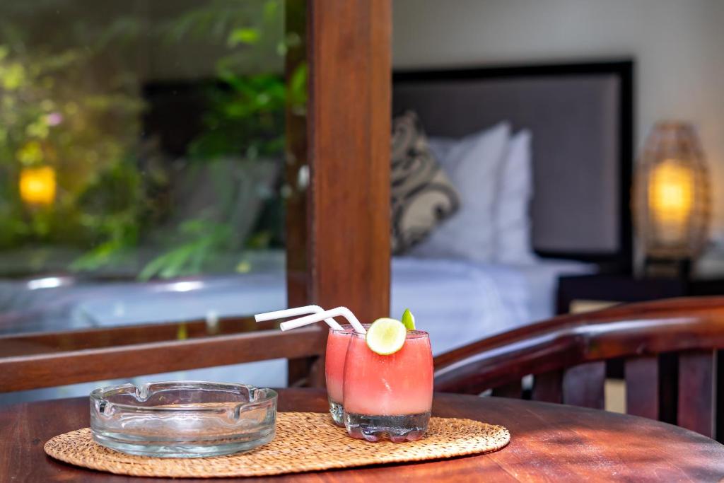 Postel nebo postele na pokoji v ubytování Gatra Ubud Inn
