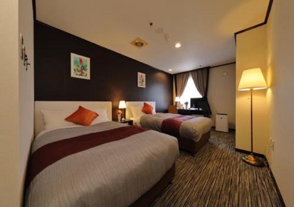 Postel nebo postele na pokoji v ubytování Garden hotel Shiunkaku Higashimatsuyama