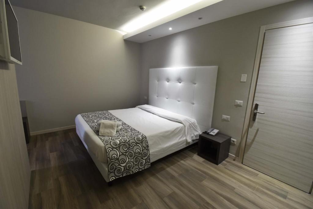 Postel nebo postele na pokoji v ubytování Hotel Riposo